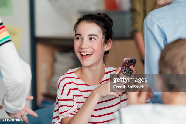 teenager laughing in class - happy teenagers phone stock pictures, royalty-free photos & images