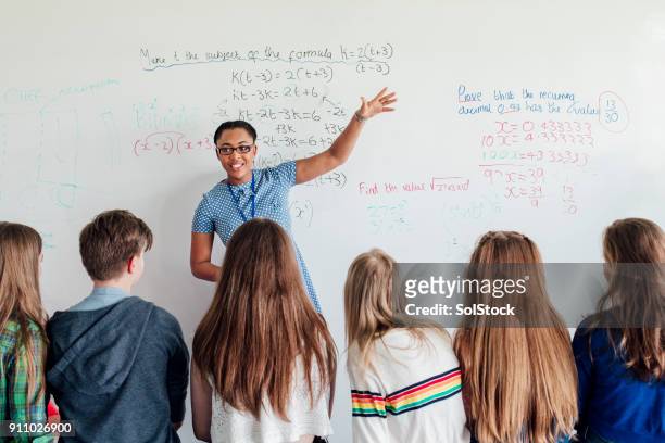 teacher giving a lesson - mathematics stock pictures, royalty-free photos & images