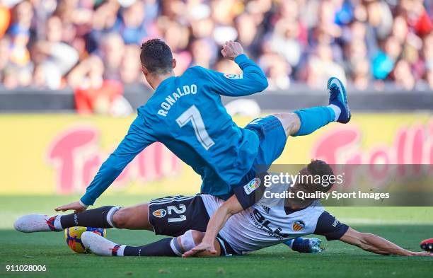 Martin Montoya of Valencia competes for the ball with Cristiano Ronaldo of Real Madrid during the La Liga match between Valencia and Real Madrid at...