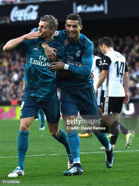 Toni Kroos of Real Madrid celebrates with teammate Cristiano Ronaldo after scoring his sides fourth goal during the La Liga match between Valencia...