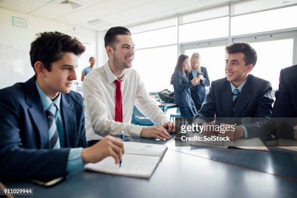 teacher laughing with students - teaching assistant stock pictures, royalty-free photos & images