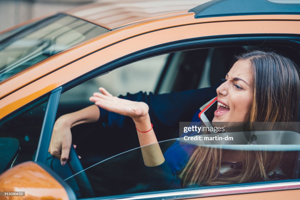 Furious woman stucked in traffic jam