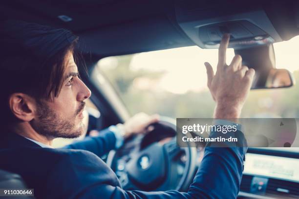 driver pressing the sos button - concept car stock pictures, royalty-free photos & images