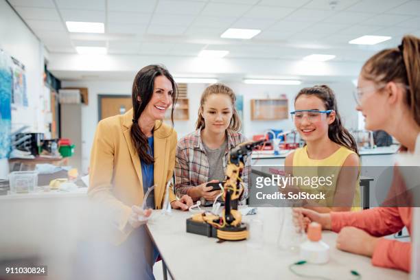 studying robotic arm - teenage girls stock pictures, royalty-free photos & images