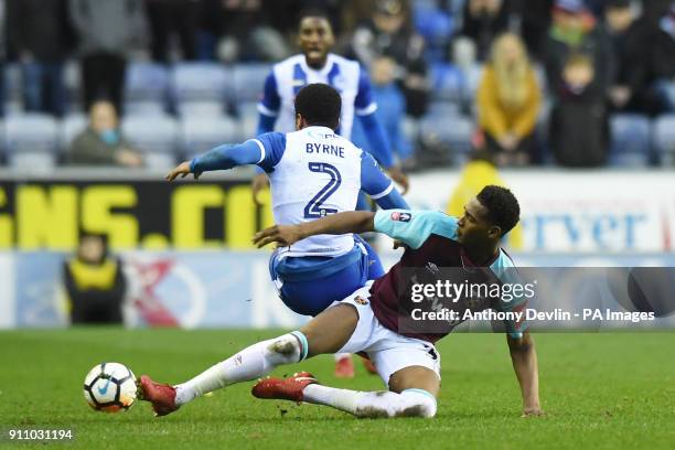 Wigan Athleticâs Nathan Byrne is tackled by West Ham United's Reece Oxford during the Emirates FA Cup, fourth round match at the DW Stadium, Wigan.