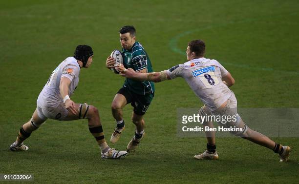 James Marshall of London Irish is tackled by Tim Cardell and Tom Willis of Wasps during the Anglo-Welsh Cup match between London Irish and Wasps at...