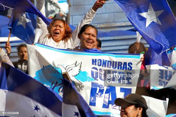 Honduran reelected President Juan Orlando Hernandez supporters cheer during the inauguration ceremony at the Tiburcio Carias Andino national stadium,...