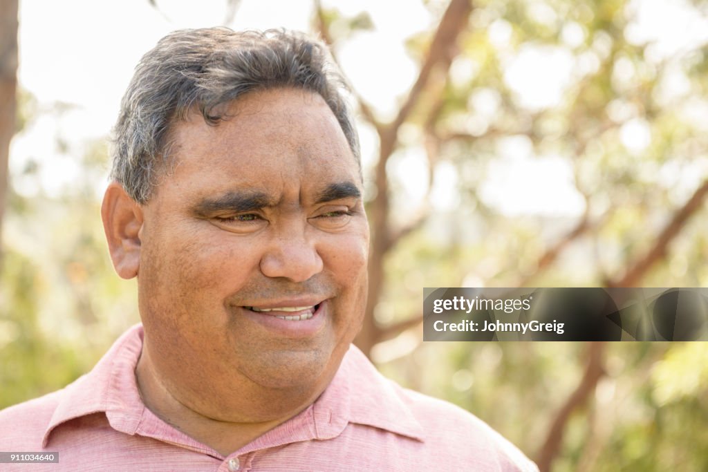 Mature Aboriginal man smiling and looking away