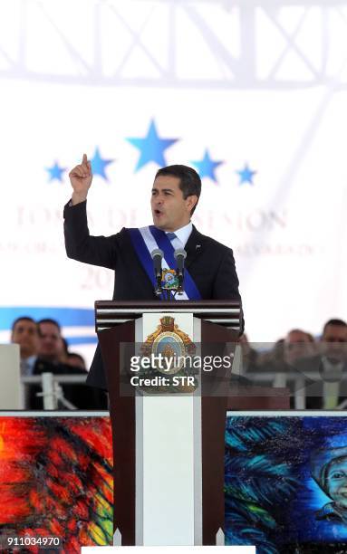 Reelected President Juan Orlando Hernandez gives a speech wearing the presidental sash during the inauguration ceremony at the Tiburcio Carias Andino...