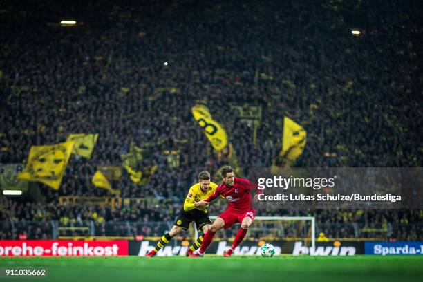Lukasz Piszczek of Dortmund and Christian Guenter of Freiburg in action during the Bundesliga match between Borussia Dortmund and Sport-Club Freiburg...