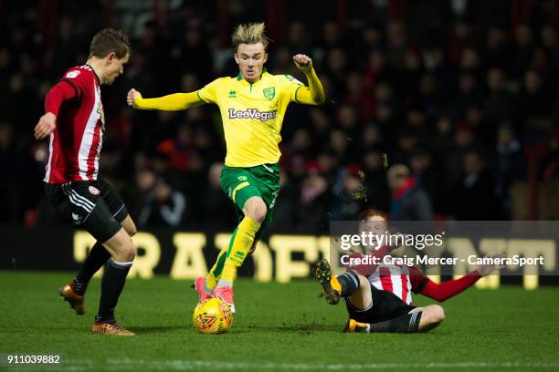 Norwich City's James Maddison evades the challenge of Brentford's Andreas Bjelland and Brentford's Ryan Woods during the Sky Bet Championship match...