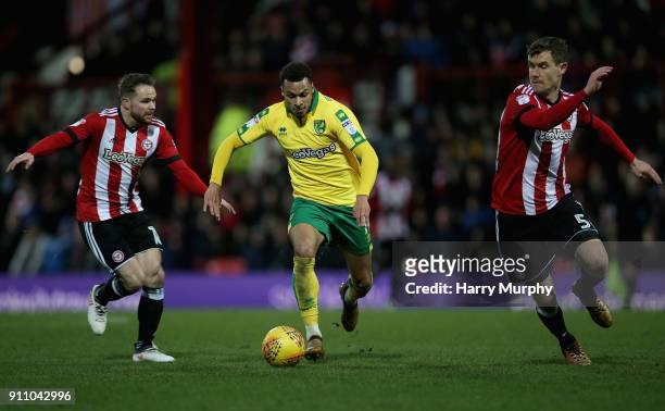 Josh Murphy of Norwich City is closed down by Alan Judge of Brentford and Andreas Bjelland of Brentford during the Sky Bet Championship match between...