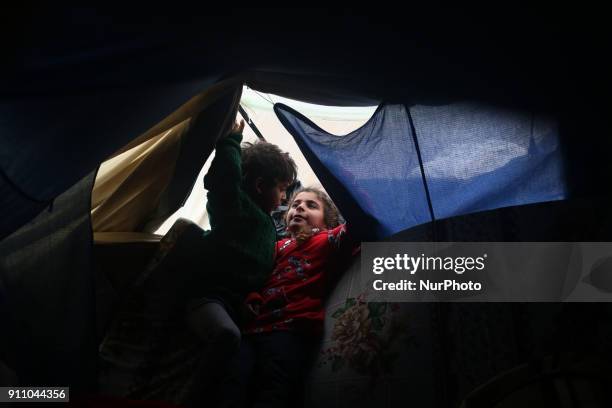 Palestinian children play inside their family's house North of Gaza City during a storm in Gaza Strip on January 27, 2018.