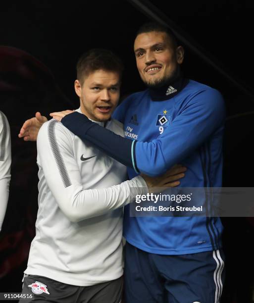 Dominik Kaiser of RB Leipzig hugs former Leipzig player Kyriakos Papadopoulos of Hamburger SV prior to the Bundesliga match between RB Leipzig and...