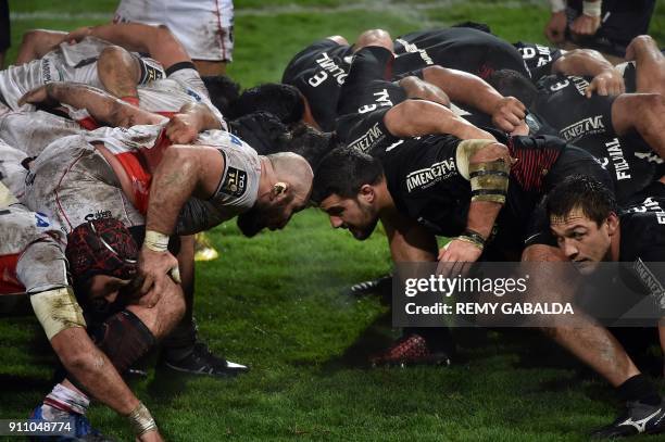 Oyonnax' Georgian prop Irakli Mirtskhulava vies with Toulouse's French hooker Julien Marchand in the scrum during the Top 14 rugby match Stade...