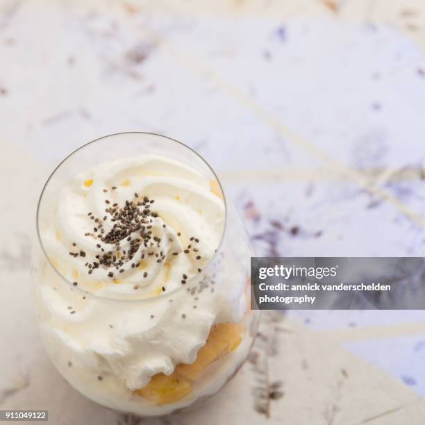 yogurt dessert with granola, mango, whipped cream and chia seed. - carotinoid stock-fotos und bilder