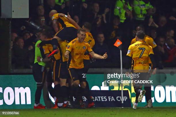 Newport County's players celebrate Padraig Amond's first half goal during the English FA Cup fourth round football match between Newport County and...