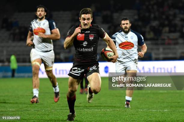 Lyon's scrumhalf Baptiste Couilloud runs on his way to score a try during the French Top 14 rugby union match between Lyon and Agen on January 27,...