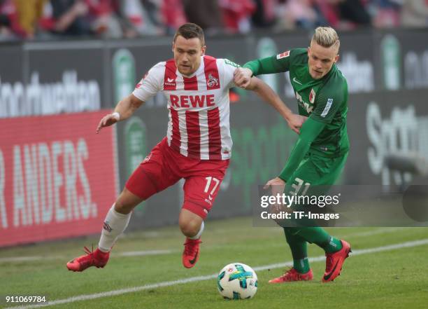 Christian Clemens of Koeln and Philipp Max of Augsburg battle for the ball during the Bundesliga match between 1. FC Koeln and FC Augsburg at...