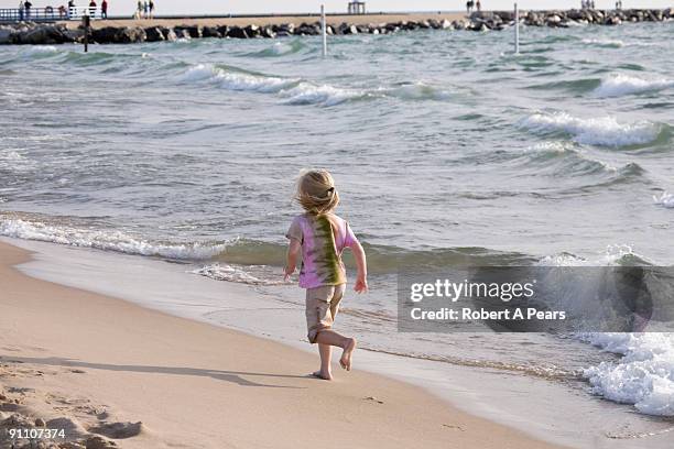 girl playing on the beach - kenni stock pictures, royalty-free photos & images