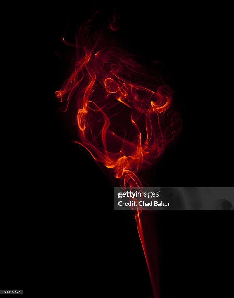 Red wisp of smoke suggesting a flower