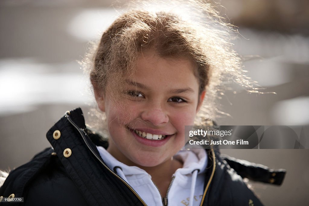 Young girl smiles in the winter sun