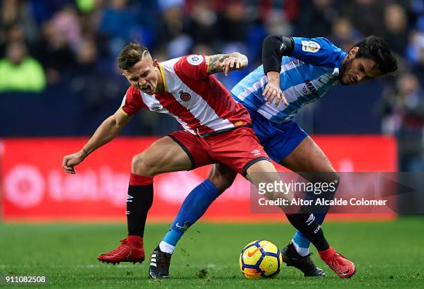 Pablo Maffeo of Girona FC competes for the ball with Jose Luis Garcia "Recio" of Malaga CF during the La Liga match between Malaga and Girona at...