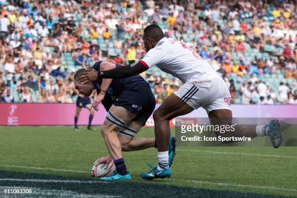 Scottish player Scott Riddell scores a try in their game against USA at the World Rugby Sevens Series at Allianz Stadium in Sydney on January 27,...