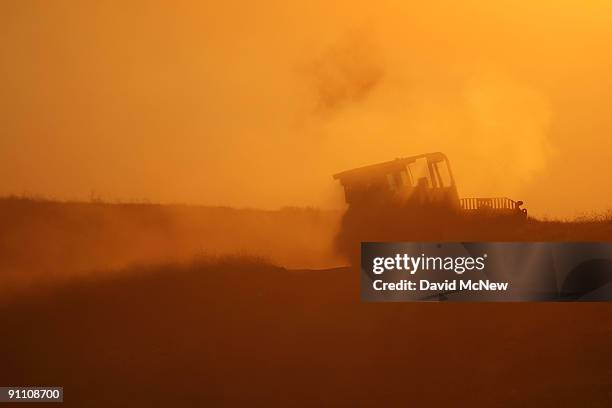 Bulldozer cuts a fireline at sunset on the eastern flank of the 16,000-plus-acre Guiberson fire, burning out of control for a second day as Red Flag...