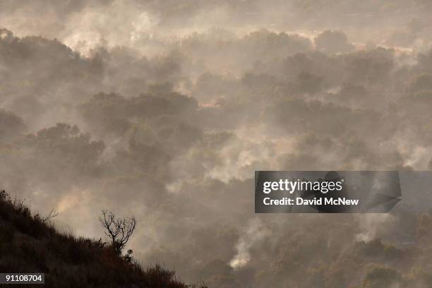 Charred landscape smolders on the eastern flank of the 16,000-plus-acre Guiberson fire, burning out of control for a second day as Red Flag warnings...