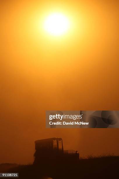 Bulldozer cuts a fireline at sunset on the eastern flank of the 16,000-plus-acre Guiberson fire, burning out of control for a second day as Red Flag...