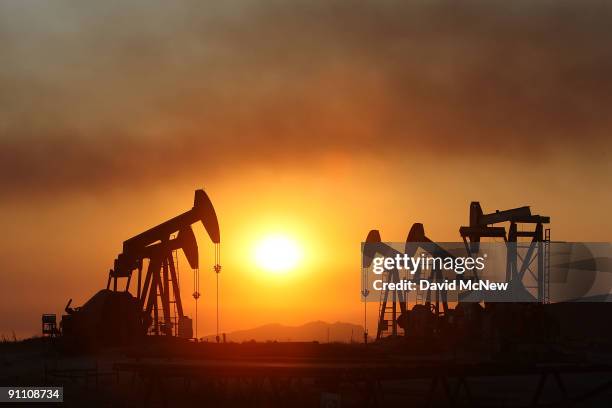 Smoke blows past oil wells at sunset on the eastern flank of the 16,000-plus-acre Guiberson fire, burning out of control for a second day as Red Flag...