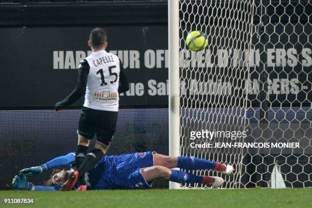 Angers' French midfielder Pierrick Capelle scores over Amiens' French goalkeeper Regis Gurtner during the French L1 Football match between Angers and...