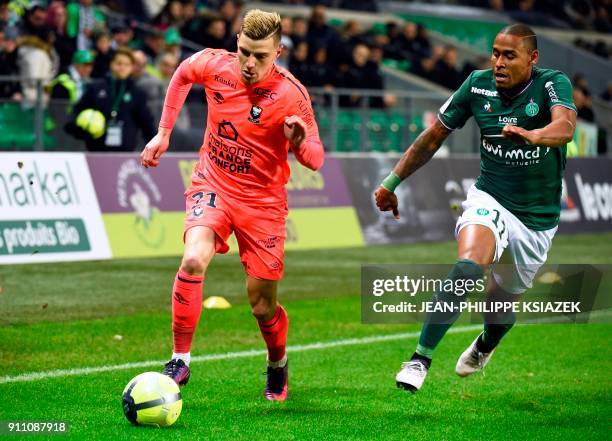 Caen's French defender Frederic Guilbert vies with Saint-Etienne's Brazilian midfielder Gabriel Antunes Da Silva during the French L1 football match...