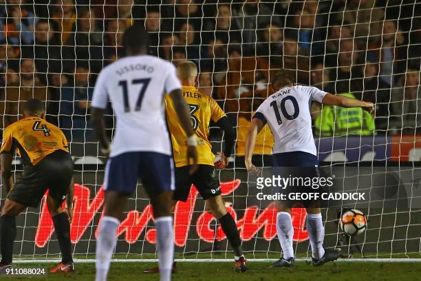 Tottenham Hotspur's English striker Harry Kane scores their first goal during the English FA Cup fourth round football match between Newport County...