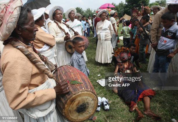 Nepalese Hindu dressed as a god rests after dancing during celebrations of the Shikali Jatra festival in Khokana village on the outskirts of...