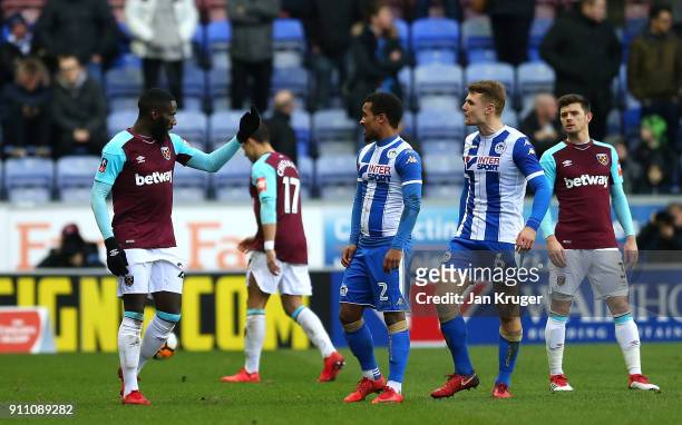 Arthur Matsuaku of West Ham United argues with Max Power of Wigan Athletic as he leaves the field after being sent-off during the Emirates FA Cup...