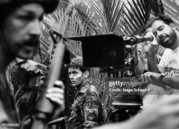 American actor Martin Sheen glances over his shoulder as director Francis Ford Coppola looks through a camera on the set of their film 'Apocalypse...