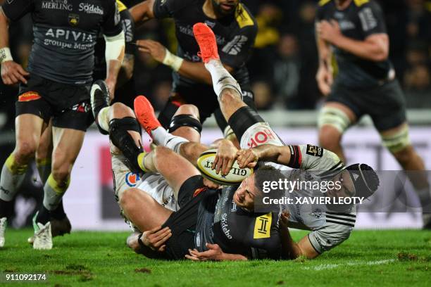 La Rochelle's New Zealander scrum-half Tawera Kerr-Barlow is tackled during the French Top 14 rugby union match between La Rochelle and Brive on...