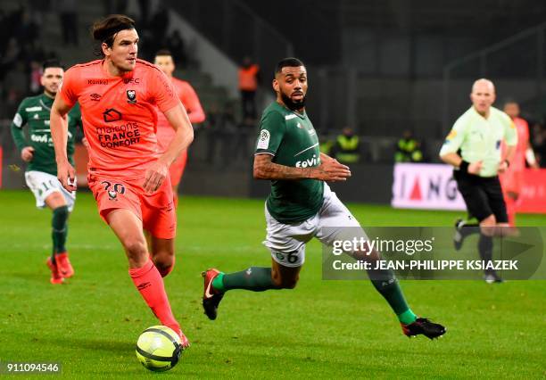 Caen's Croatian forward Ivan Santini vies with Saint-Etienne's French midfielder Yann M'Vila during the French L1 football match between...