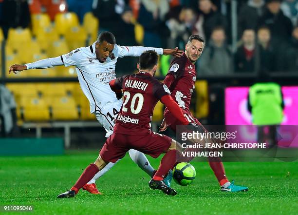 Metz's French defender Julian Palmieri and Metz' Serbian defender Vahid Selimovic vie for the ball with Nice's French forward Alassane Plea during...