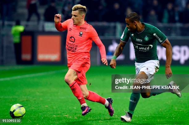 Caen's French defender Frederic Guilbert vies with Saint-Etienne's Brazilian midfielder Gabriel Antunes Da Silva during the French L1 football match...