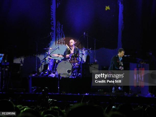 Will Champion and Chris Martin of Coldplay perform on stage at Wembley Stadium on September 18, 2009 in London, England.