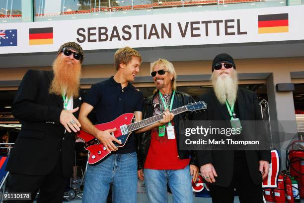 Sebastian Vettel of Germany and Red Bull Racing meets members of the U.S. Rock band ZZ Top, Billy Gibbons , Frank Beard and Dusty Hill during...