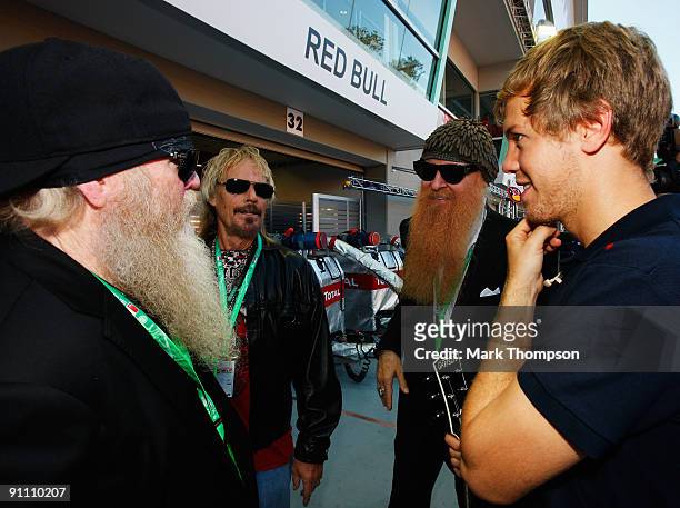 Sebastian Vettel of Germany and Red Bull Racing meets members of the U.S. Rock band ZZ Top, Billy Gibbons , Frank Beard and Dusty Hill during...