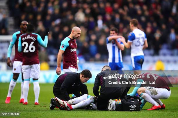 Pedro Obiang of West Ham United receives treatment during the Emirates FA Cup Fourth Round match between Wigan Athletic and West Ham United on...