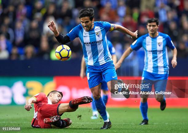 Jose Luis Garcia "Recio" of Malaga CF being fouled by Pere Pons of Girona FC during the La Liga match between Malaga and Girona at Estadio La...