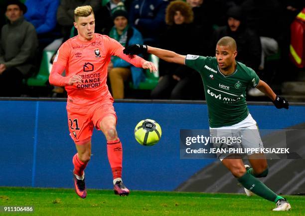 Caen's French defender Frederic Guilbert vies with Saint-Etienne's French forward Kevin Monnet-Paquet during the French L1 football match between...