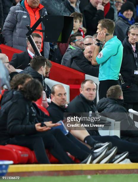 Craig Pawson, match referee, watches the VAR screen before awarding a penalty to Liverpool during The Emirates FA Cup Fourth Round match between...