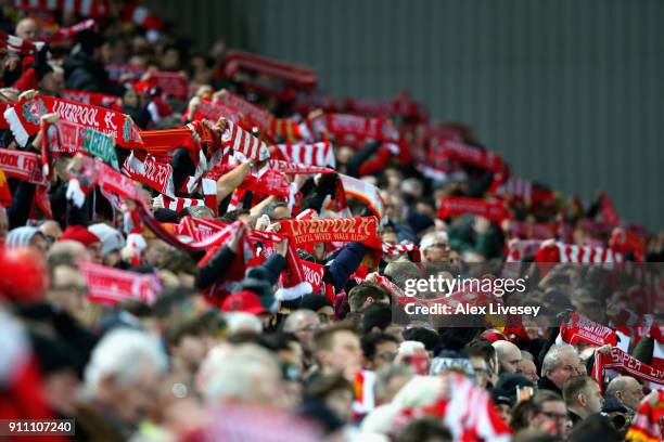 Liverpool supporters hold up their scarves as they sing prior to The Emirates FA Cup Fourth Round match between Liverpool and West Bromwich Albion at...